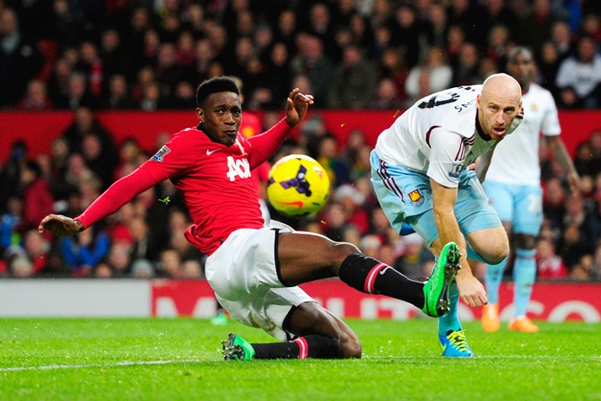 Danny Welbeck of Manchester United competes with James Collins of West Ham United
