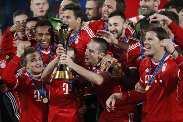 Germany's Bayern Munich Franck Ribery (2nd R) and Philipp Lahm hold the trophy as they celebrate with their team mates after winning their 2013 FIFA Club World Cup final soccer match against Morocco's Raja Casablanca at Marrakech stadium