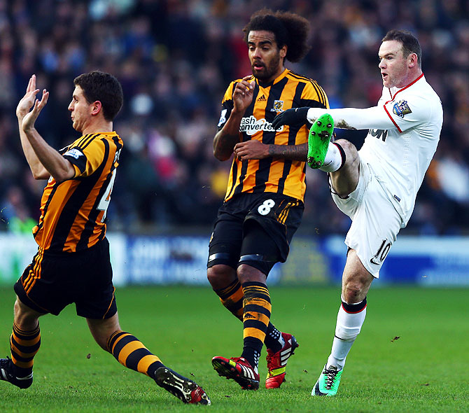 Wayne Rooney (right) of Manchester United shoots and scores his sides second goal against Hull City