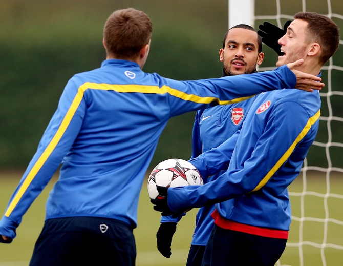 Theo Walcott enjoys a joke with Thomas Vermaelen during an Arsenal training session