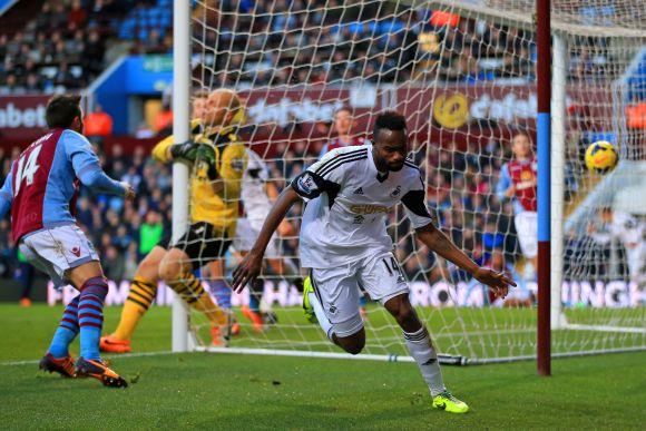 Roland Lamah of Swansea City turns to celebrate after scoring their first goal past Brad Guzan of Aston Villa during the Barclays Premier League match 