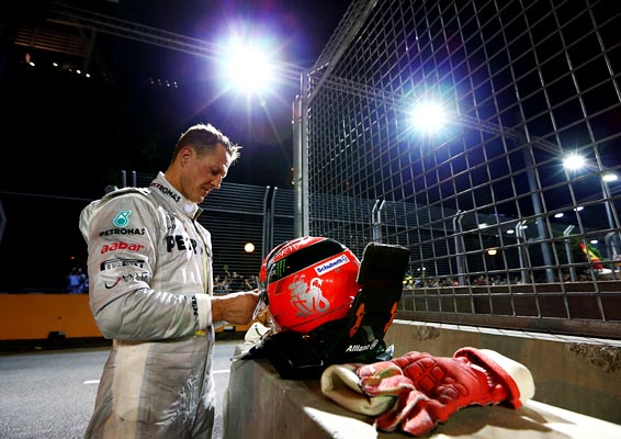 Michael Schumacher of Mercedes retires early after crashing into the back of Jean-Eric Vergne of France and Scuderia Toro Rosso during the Singapore GP on September 23, 2012