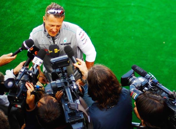 Michael Schumacher of Mercedes GP is interviewed by the media during previews to the  Belgian GP at Spa Francorchamps on August 30, 2012