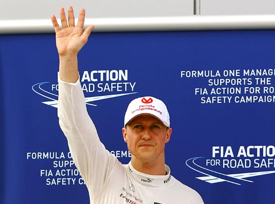 Third-placed Michael Schumacher of Mercedes celebrates in parc ferme following qualifying for the Malaysian GP on March 24, 2012