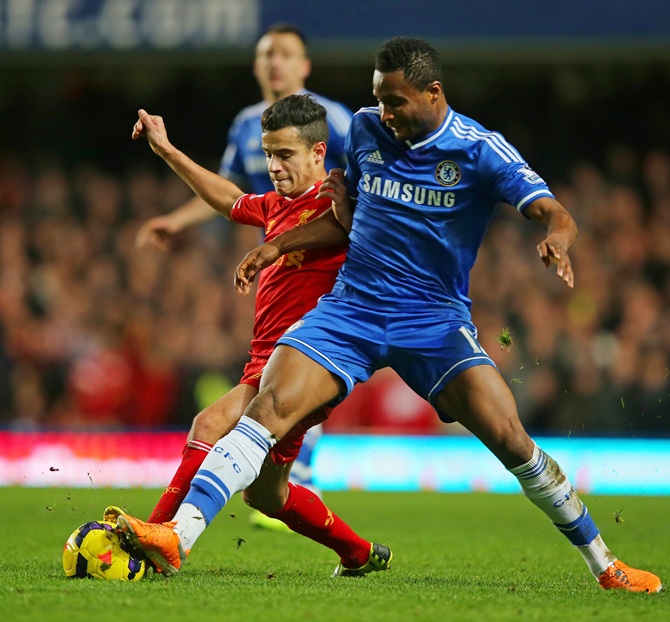 Philippe Coutinho of Liverpool and John Obi Mikel of Chelsea compete for the ball