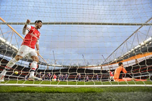 Arsenal's Olivier Giroud celebrates after Lukas Podolski scored against Stoke City