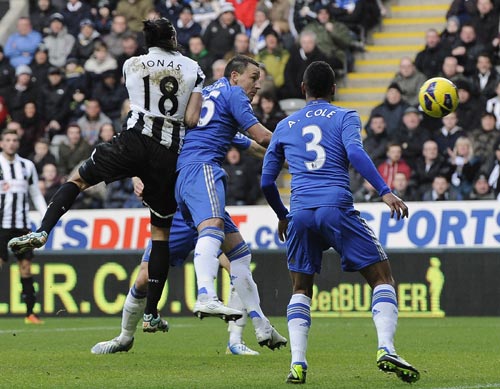 Newcastle United's Jonas Gutierrez (L) heads to score against Chelsea