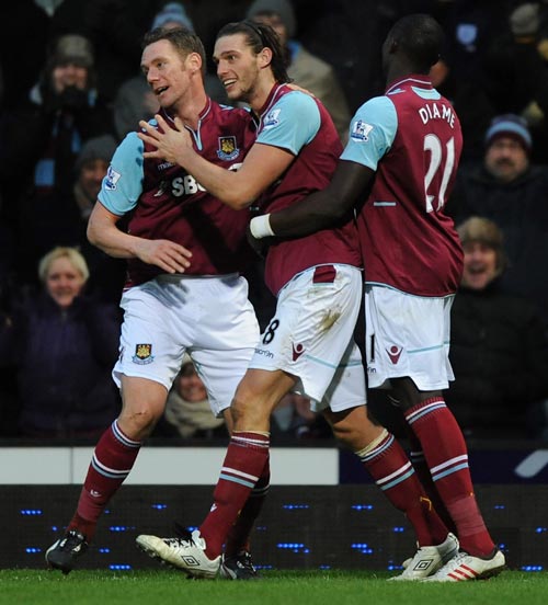 Andy Carroll (C) of West Ham United celebrates scoring the first and only goal of the game with Kevin Nolan (L) and Mohamed Diame during the Barclays Premier League match