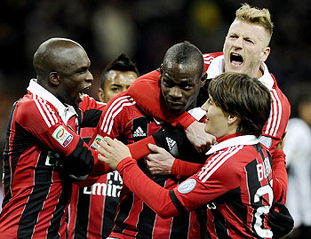 AC Milan's Mario Balotelli (centre) celebrates with teammates after scoring his second goal from the penalty spot on Sunday