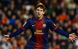 Barcelona'S Lionel Messi celebrates after scoring against Valencia on Sunday