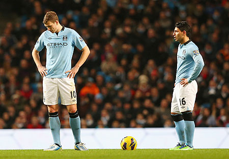 Manchester City's Edin Dzeko and Sergio Aguero (right) wear a dejected look after concedin a second goal against Liverpool on Sunday