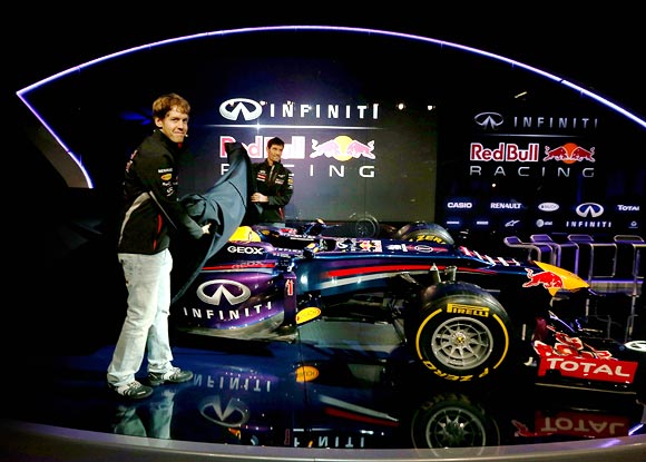 Sebastian Vettel and team mate Mark Webber reveal the Red Bull's new car RB9 for the 2013 season