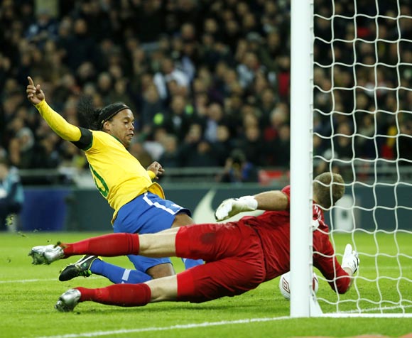 Ronaldinho's penalty is saved by England goalkeeper Joe Hart