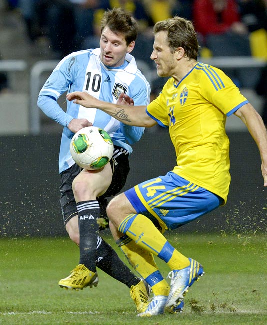Argentina captain Lionel Messi in a tussle for the ball against Sweden's Tobias Hysen