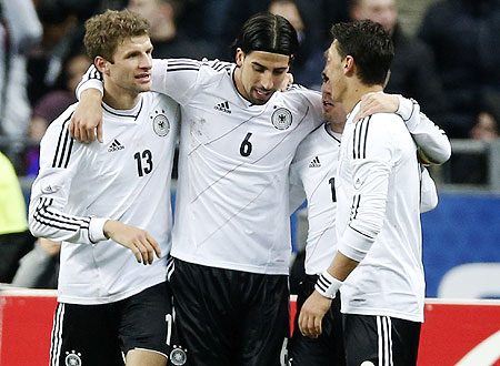Germany's Thomas Muller (left), Sami Khedira (centre) and Mesut Oezil (right) celebrate after scoring against France during their international friendly at the Stade de France  on Wednesday