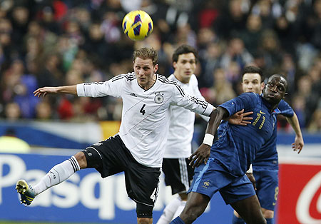 Germany's Benedikt Hoewedes (left) challenges France's Moussa Sissoko (right) during their friendly on Wednesday