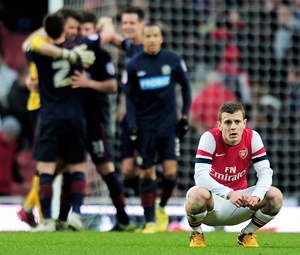 A dejected Jack Wilshere of Arsenal reacts
