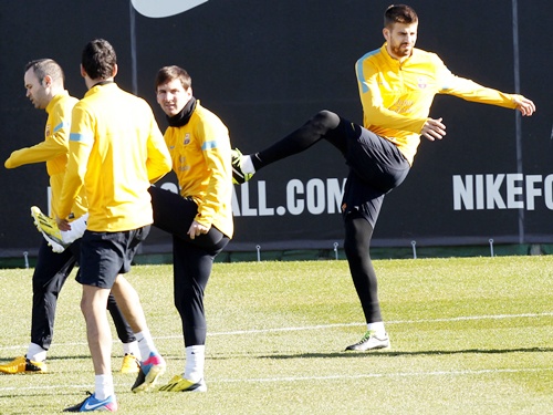 From left: Barcelona's Andres Iniesta, Sergio Busquets, Lionel Messi and Gerard Pique exercise during a training session