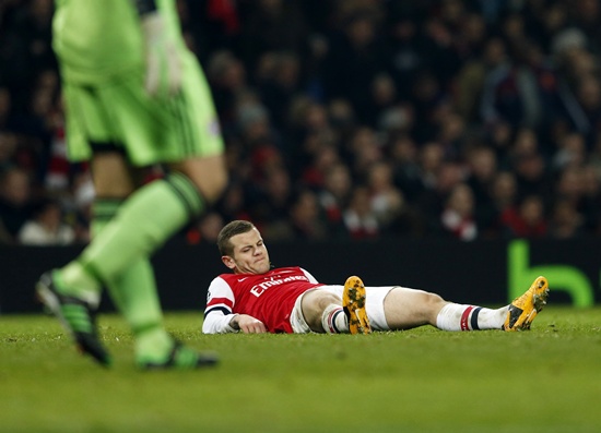 Arsenal's Jack Wilshere lies on the ground