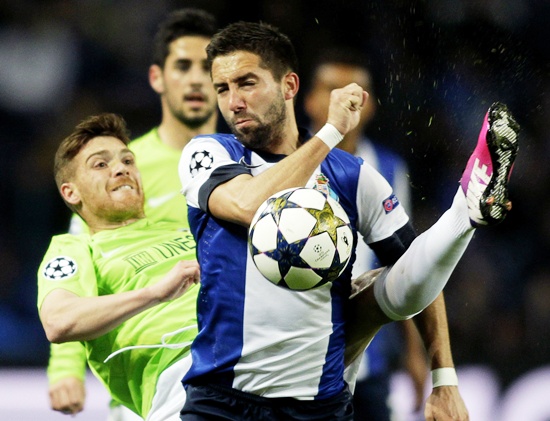 Porto's Joao Moutinho (right) is challenged by Malaga's Antunes