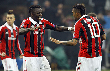 AC Milan's Sulley Muntari (left) celebrates with teammate Kevin-Prince Boateng after scoring against Barcelona on Wednesday
