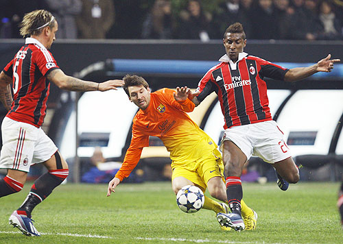 AC Milan's Kevin Constant (right) challenges Barcelona's Lionel Messi (centre) during their Champions League match on Wednesday