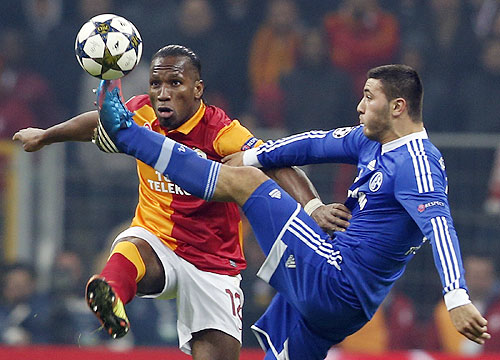 Galatasaray's Didier Drogba (left) is challenged by Schalke 04's Sead Kolasinac (right) during their Champions League match on Wednesday