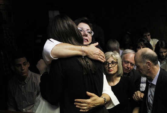 Relatives of Oscar Pistorius hug each other