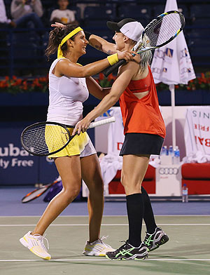 Bethanie Mattek-Sands of USA (right) celebrates with partner Sania Mirza of India after defeating Nadia Petrova of Russia and Katerina Srebotnik of Slovenia to win win the WTA Dubai Duty Free Tennis Championship doubles final on Saturday