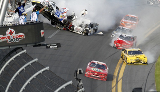 NASCAR driver Tony Stewart (bottom right) avoids a crash on the last lap