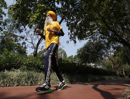 Fauja Singh jogs during a practise at a park in Hong Kong