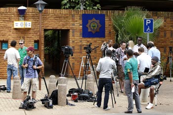 South African journalist wait outside court