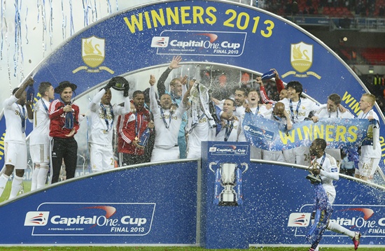 Swansea City players celebrate with the trophy