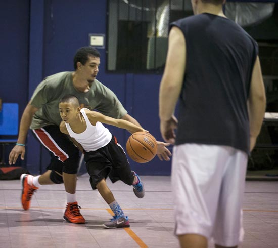 Julian Newman participates in Friday evening pickup basketball games at Downey Christian School in Orlando, Florida