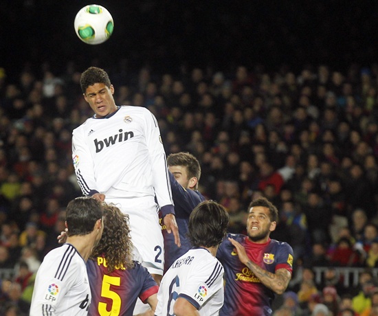 Real Madrid's Rafael Varane heads the ball to score a goal against Barcelona