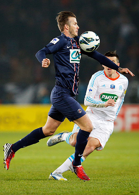 PSG'S David Beckham runs past Marseille's Joey Barton during their Ligue 1 tie on Wednesday