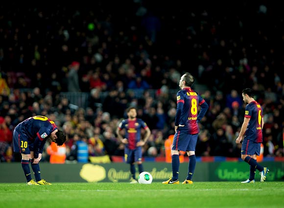 Barcelona players wear a dejected look after losing to Real Madrid