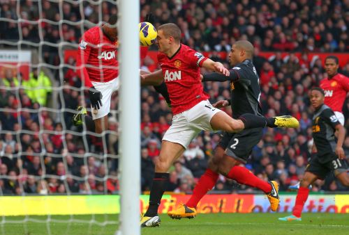 Nemanja Vidic of Manchester United scores the second goal from a deflected Patrice Evra header during the Barclays Premier League match between Manchester United and Liverpool