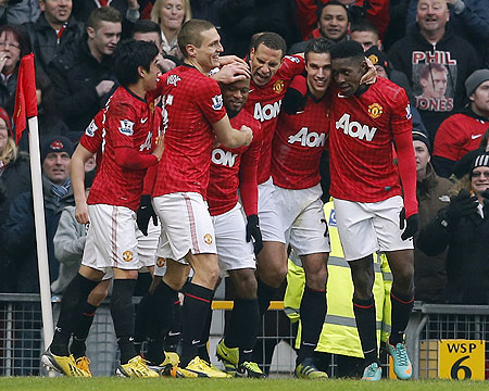Manchester United's Patrice Evra (centre) celebrates his goal with teammates after scoring against Liverpool