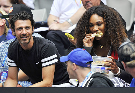 Serena Williams and boyfriend Patrick Mouratoglou (left) watch Venus Williams in action on Monday
