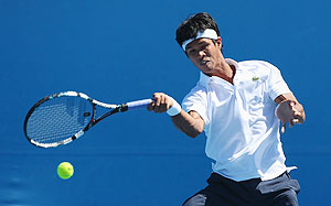 Somdev Devvarman of India plays a forehand in his first round match against Bjorn Phau of Germany
