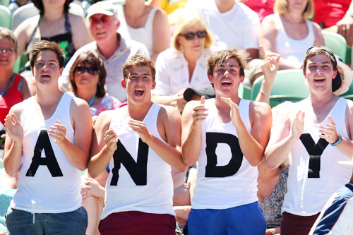 Supporters watch Andy Murray of Great Britain