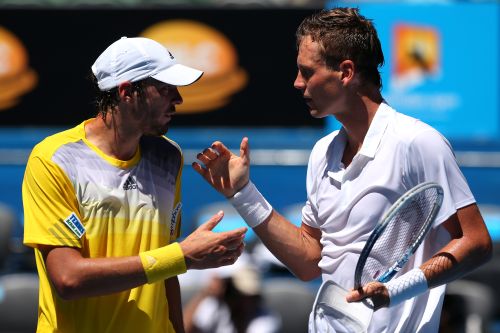 Tomas Berdych (R) of the Czech Republic shakes hands with Guillaume Rufin of France