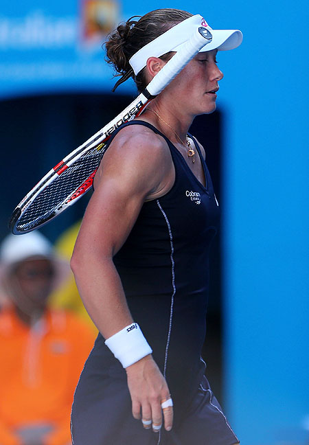 Sam Stosur walks to the net after losing her second round match against Jie Zheng of China
