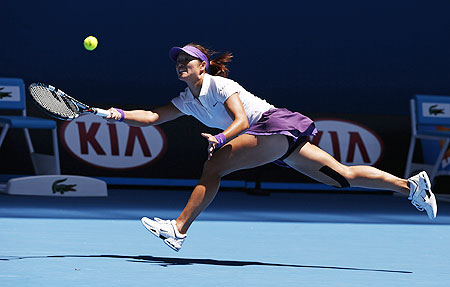 Li Na hits a return to Olga Govortsova of Belarus during their women's singles match on Wednesday