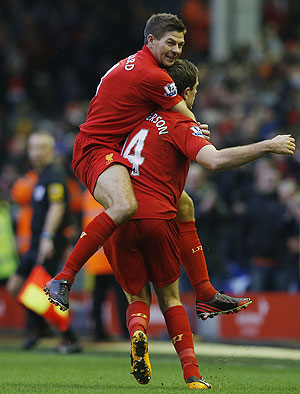 Liverpool's Jordan Henderson (right) and teammate Steven Gerrard celebrate after scoring during their English Premier League match against Norwich City on Saturday