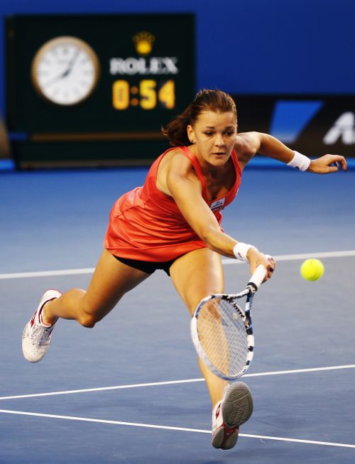 Agnieszka Radwanska of Poland hits a return to Ana Ivanovic of Serbia