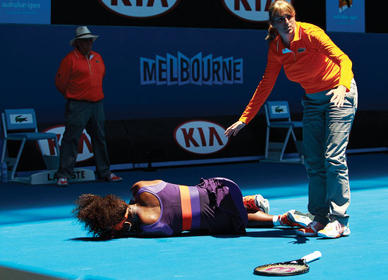 Serena Williams lies on the ground
