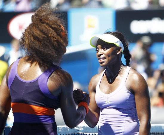 Sloane Stephens (right) shakes hands with Serena Williams