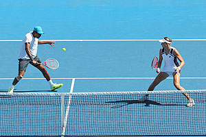 Nadia Petrova of Russia and Mahesh Bhupathi of India in action during their mixed doubles quarter-final against Jarmila Gajdosova and Matthew Ebden of Australia on Thursday